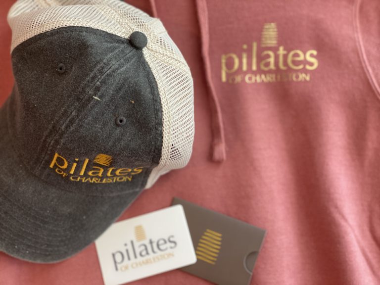 Comfortable Pilates of Charleston branded cap and hoodie for workout sessions and athleisure wear.