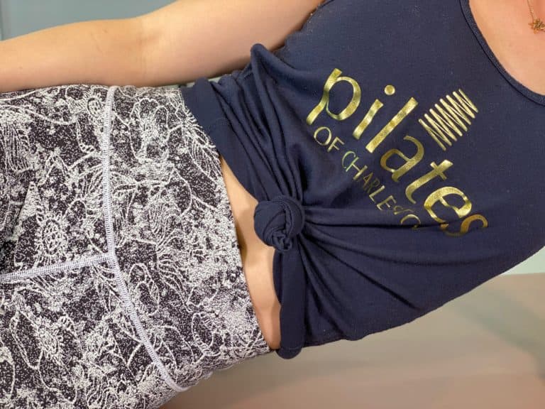 Comfortable casual workout outfit featuring Pilates of Charleston logo top and patterned leggings.