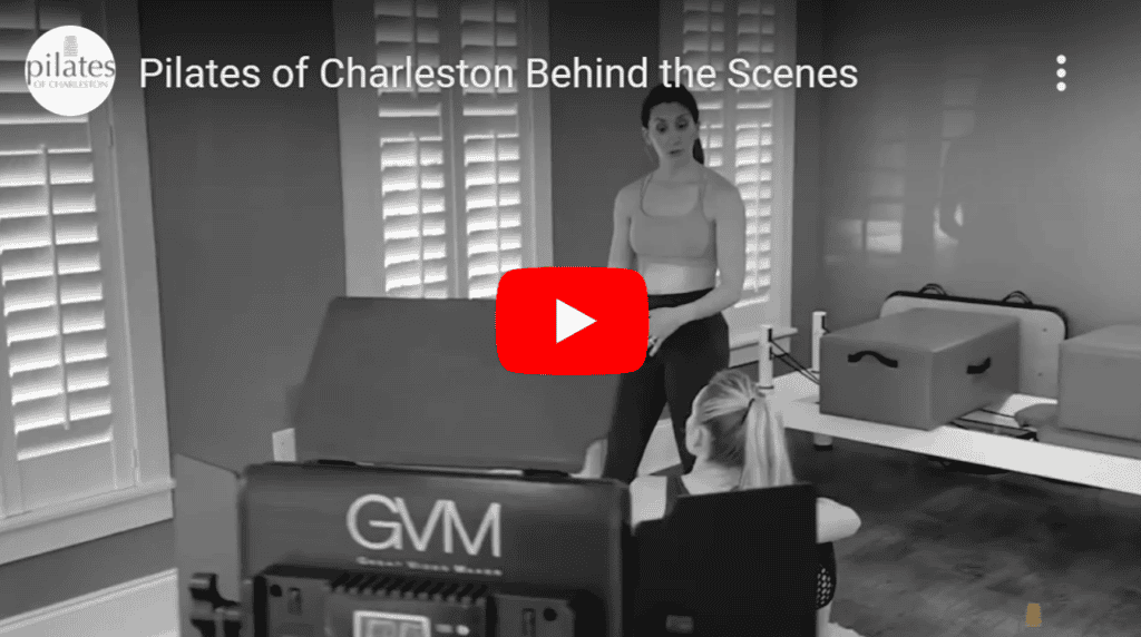 Indoor Pilates class at Charleston studio with instructor guiding client exercises.