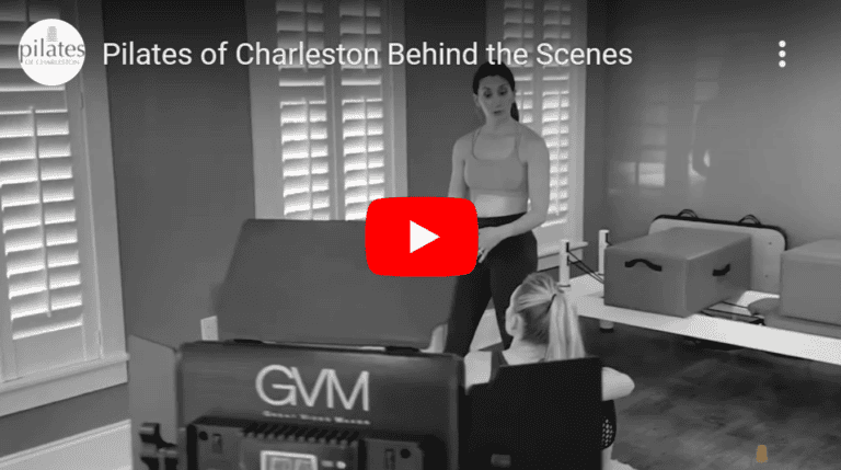 Indoor Pilates class at Charleston studio with instructor guiding client exercises.