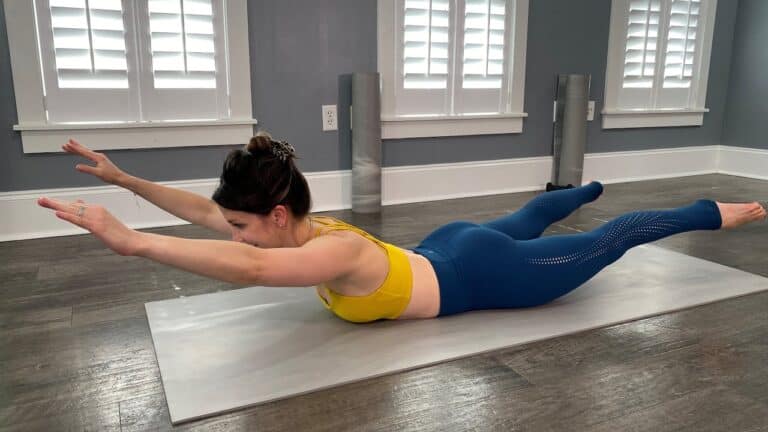 Women doing Pilates exercises at studio for core strength and flexibility.