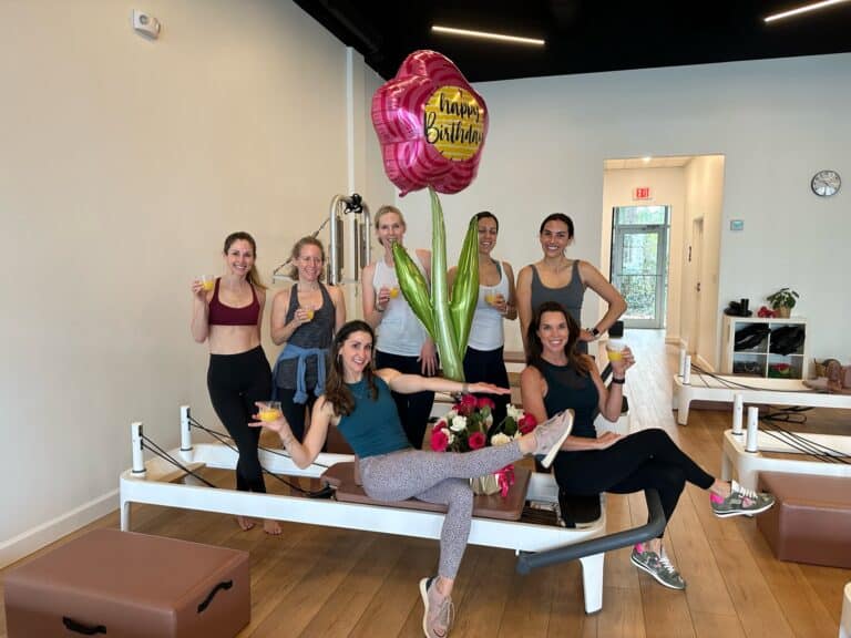 Vibrant group workout session at a Pilates studio, highlighting health, fitness, and community.