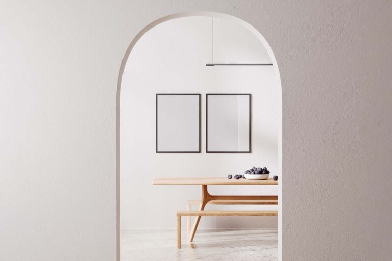 Bright, clean Pilates studio featuring a wooden bench, framed mirrors, and a bowl of blueberries, perfect for Pilates of Charleston classes.