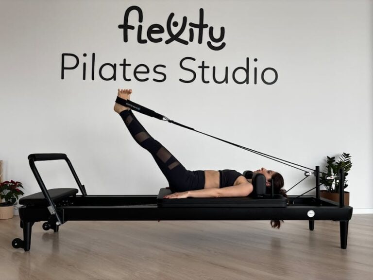 Woman performing a strength focused reformer Pilates exercise